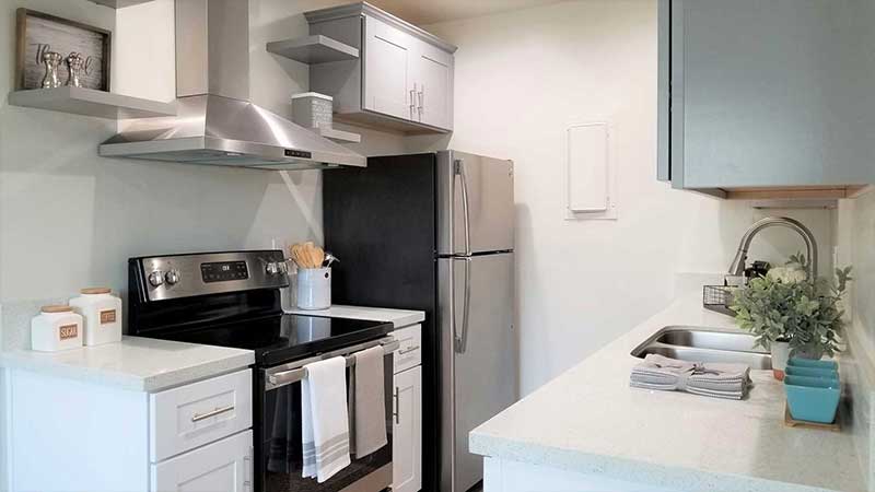 Kitchen stove and refrigerator interior photo of Bleu Apartments