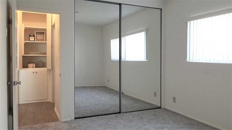 Bedroom and mirrored closet interior photo of Bleu Apartments