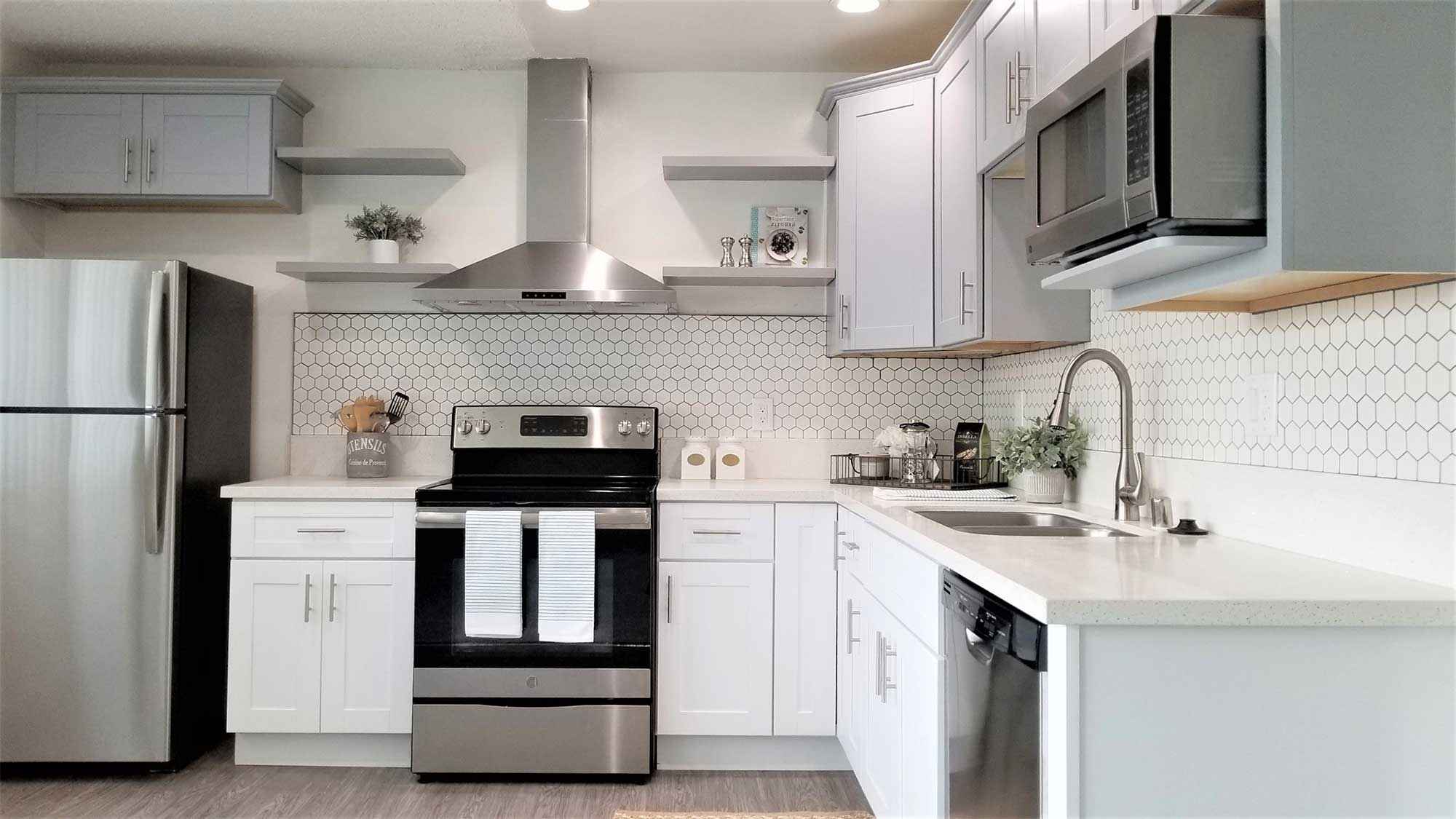 Bleu Apartments renovated kitchen with hexagon tile backsplash