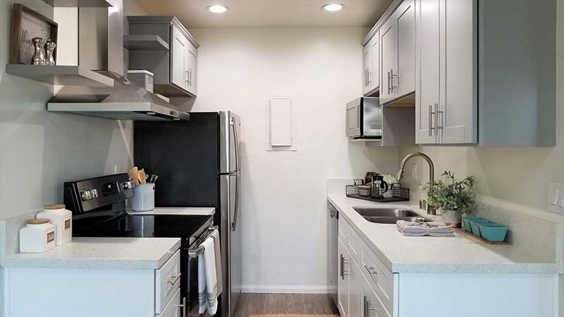 Kitchen with appliances interior photo of Bleu Apartments