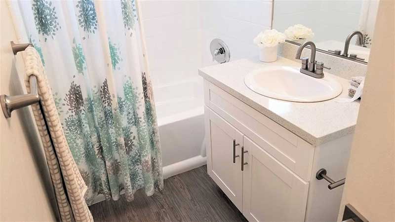 Bathroom sink and tub interior photo of Bleu Apartments